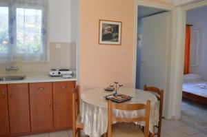 a kitchen with a table and a sink and a bed at Elli Studios & Apartments in Marathokampos +36 photos