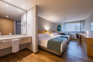 Voodi või voodid majutusasutuse Hotel Estelar Blue toas