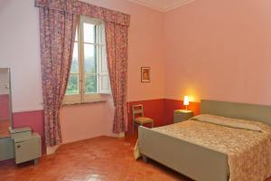 a bedroom with a bed and a window at Holiday House Taormina in Trappitello