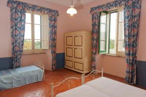 a bedroom with two windows and a bed at Holiday House Taormina in Trappitello