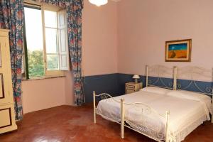 a bedroom with a bed and a window at Holiday House Taormina in Trappitello +10 photos