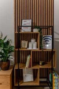 a book shelf with items on top of it at Garbo 3 bedroom Kosice Centrum Very NEW in Košice
