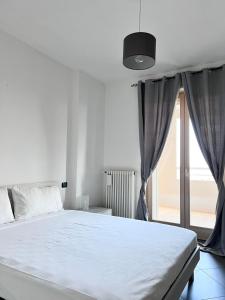 a white bed in a room with a window at Best Stay-Airport Bari Palese in Macchie