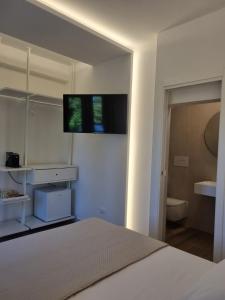 a bedroom with a bed and a television on the wall at Affittacamere La Nuvola in Chieti