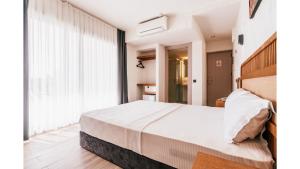 a bedroom with a bed and a large window at Sirius Mİ Sun Paradise Hotel Çeşme in Çeşme +55 photos