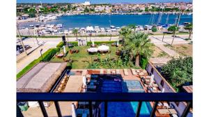 an aerial view of a resort with a pool and a harbor at Sirius Mİ Sun Paradise Hotel Çeşme in Çeşme