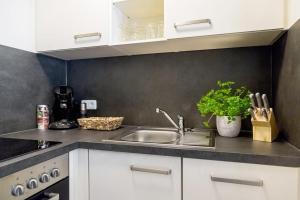 a kitchen with a sink and a counter top at Wildgrün Maxi Lodge 7 in Pfronten
