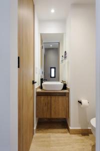 a bathroom with a tub and a sink and a mirror at Casa Colon in Mexico City