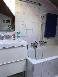 a bathroom with a shower and a sink and a tub at casa ad Avegno con 1500mq di giardino in Avegno