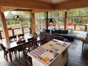 a living room with a couch and a table and chairs at Les Chalets Double K # 2 in Saint-Alexis-des-Monts