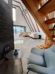 a living room with a blue couch and a table at Villa Bosanska Zvijezda in Vlasic +37 photos
