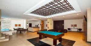 a living room with a pool table in it at Ecuabook torre sol 32 mall del Sol in Guayaquil