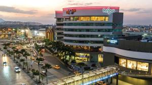 a building with a sign on the side of a street at Ecuabook torre sol 32 mall del Sol in Guayaquil