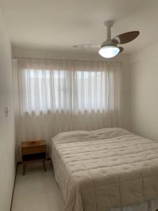 a bedroom with a bed and a ceiling fan at Villa Andorinha, Ap Vista para Montanha in Mucugê +25 photos