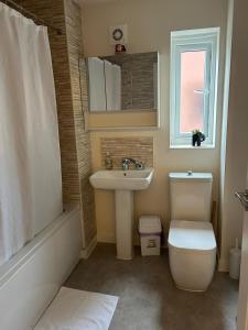 a bathroom with a sink and a toilet and a window at Guest Village in Hull +13 photos