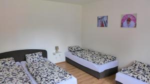 two beds in a small room with two mattresses at Ubytování u vinaře in Břeclav