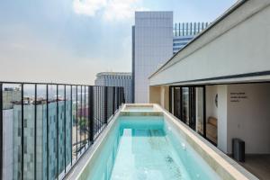 a balcony with a swimming pool on top of a building at Casa Colon in Mexico City