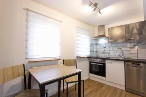 a kitchen with a wooden table and a sink at Citystudio 3 Rosenburgblick in Moselnähe in Zeltingen-Rachtig