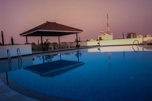 a swimming pool with a gazebo on top of a building at Park Connect in Cochin