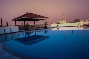 a swimming pool with a gazebo on top of a building at Park Connect in Cochin