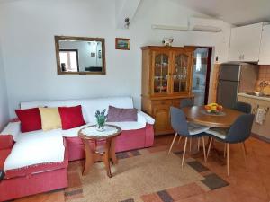 a living room with a couch and a table at Cozy Family Apartment Aleksandar in Pula