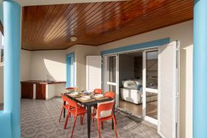 a dining room with a table and chairs and a bed at Fontinha by An Island Apart in Porto Santo +43 photos