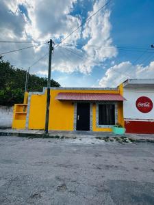 a yellow and red building with a cocacola sign on it at Casita Salome in Valladolid