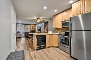 a kitchen with wooden cabinets and a stainless steel refrigerator at Silvertown Condos by Park City Vacations in Park City