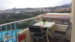 a table and chairs on a balcony with a view at Minerva909 in Benalmádena