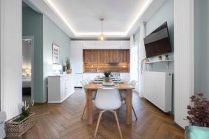a kitchen and dining room with a table and chairs at Homevision - Architectural Condo in Thessaloniki