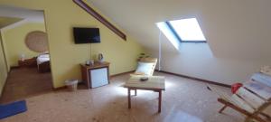 a living room with a couch and a tv at Casa TIANA in Mindelo