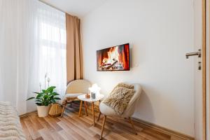 a living room with two chairs and a table at Karlsbad Apartments in Karlovy Vary