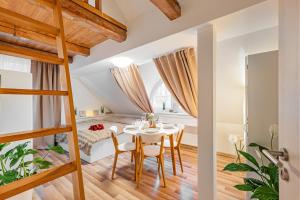 a room with a table and chairs and a bed at Karlsbad Apartments in Karlovy Vary
