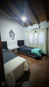a bedroom with a bed and a window at La Cabaña en Lujan de Cuyo! in Ciudad Lujan de Cuyo