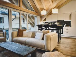 a living room with a couch and a dining room at Hidden Retreats The Lohner in Reichenbach