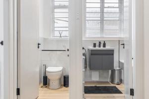 a bathroom with a toilet and a sink at Cozy and spacious full size flat in London