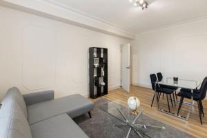 a living room with a couch and a table at Cozy and spacious full size flat in London
