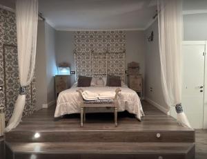 a bedroom with a bed with curtains and a window at Puerta de Alcaraz in Alcaraz