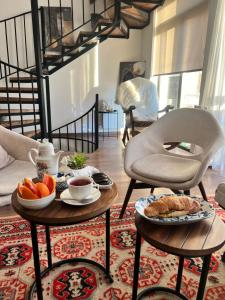 a living room with a coffee table with food on it at Station Boutique in Gyumri