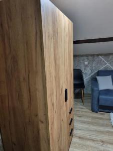 a wooden door in a room with a bed at Dom Kopernica 5 in Chełm +16 photos