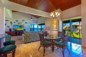a living room with a table and chairs and a couch at WAILEA ELUA, #1302 condo in Wailea