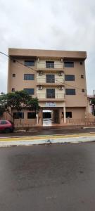 a large building on the side of a street at Âncora Hotel in Faxinal