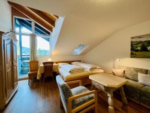 a attic room with two beds and a couch at Zickenstüble B19 Montana Haus in Oberstdorf +19 photos
