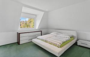 a white bedroom with a bed and a window at Lovely Home In Dassendorf With Wifi in Dassendorf +10 photos