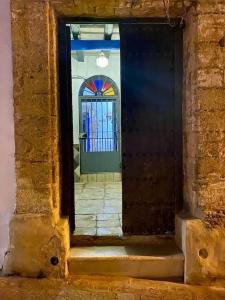 a doorway to a door with a stained glass window at La Fuente 16 Vivienda Rural in Vejer de la Frontera