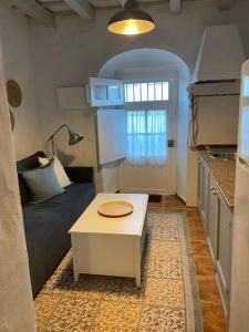 a living room with a couch and a table at La Fuente 16 Vivienda Rural in Vejer de la Frontera