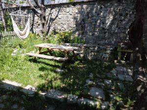 a wooden picnic table in front of a stone wall at L'Aussoyenne in Aussois