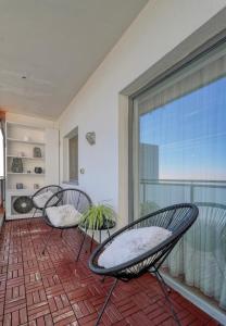 a room with two chairs and a large window at 14th Luxury Flat in Bucharest
