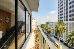 a balcony with palm trees and buildings at Casa Colon in Mexico City