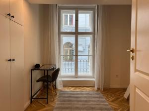a room with a large window and a chair at Szentkiralyi Suite in Budapest +9 photos